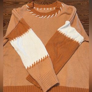 Women’s orange and white sweater